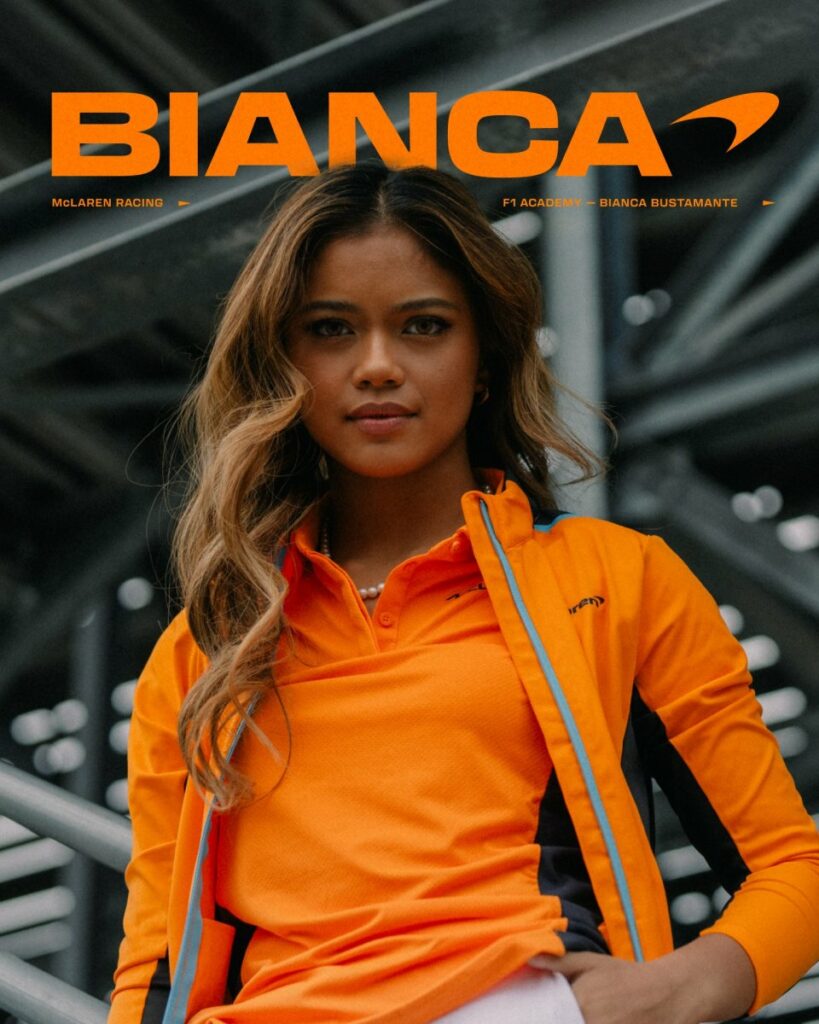 young filipina 18y/o wearing orange McLaren merch after recent signing with said team posing for the camera