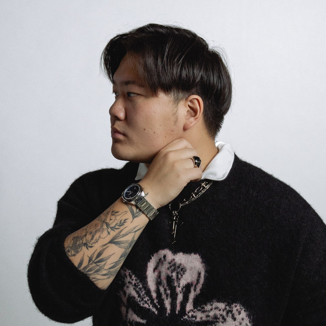 31y/o korean DJ posed for the camera looking left displaying side profile